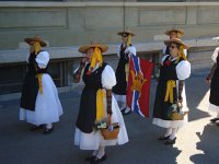 DSC05744  women in traditional dress fidgeting (maybe yawning) before the parade begins