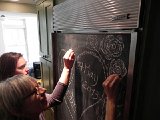DSCN7224  Who proposed a drawing on the chalkboard front of the refrigerator?