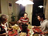20141224 193805  Christine, Bri and Nico dip bread and vegetable into rosemary, porcini and sun-dried tomato flavored fondues