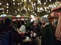 20151216 202133  At the end of our walking tour of Zurich, we celebrated with some vin chaud in a square whose main attraction was a riser drapped in greenery so people&#39;s heads poked out while they sang carols