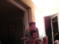 DSCN4225  Brigitte and Nicolas catch up while opening their birthday presents on the balcony.