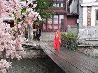 DSCN6593  Back in town a little tourist girl all duded up in Naix garb. Dad awaits with camera