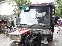 DSCN6609  This is a single cylinder diesel powered cross between a rototiller and a pickup truck, probably one of the least safe devices I have ever seen.