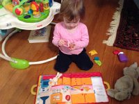 IMG 3708  Then we got the cloth and zipper bunny story book. She has come a LONG way since she first started playing with it! Now SHE can read the book to the bunny herself. She also enjoys taking off the clothes, using the wash cloth, too!