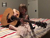 IMG 6586  Here she actually makes sounds! When will she be ready to focus some attention and take a few lessons on an instrument more her size?