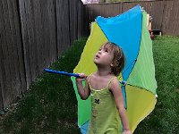 IMG 6610  Afternoon in the back yard Val finds the parasol to be the best toy. She is trying to see the bird which she can hear