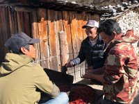 Mingma and the porters can't help themselves: they help the proprietress process her chillies
