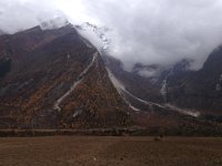 whisps of blue sky above the high peaks, larch on the slopes