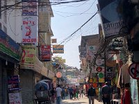 At least this stretch of road is paved. Very different than parallel road (it seems to be mostly pedestrian tourists)