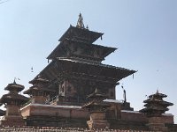 Temples in Durbar Square visible above the out wall lined with shops