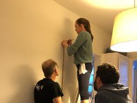 Measuring to hang the framed poster