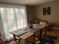 A large dinning area with sliding glass doors to the back yard