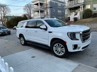 Our (huge) GMC Yukon parked in front of our unit