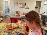 Val studies her gouache paints. She thinks she's ready