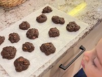 Much baking: Liam eyes the batch of chocolate chocolate chip cookies